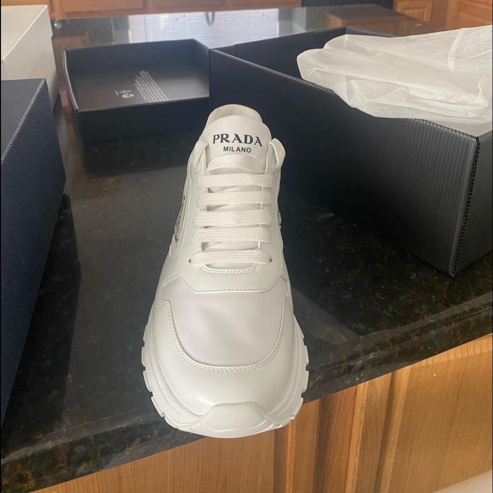 All white Prada sneakers